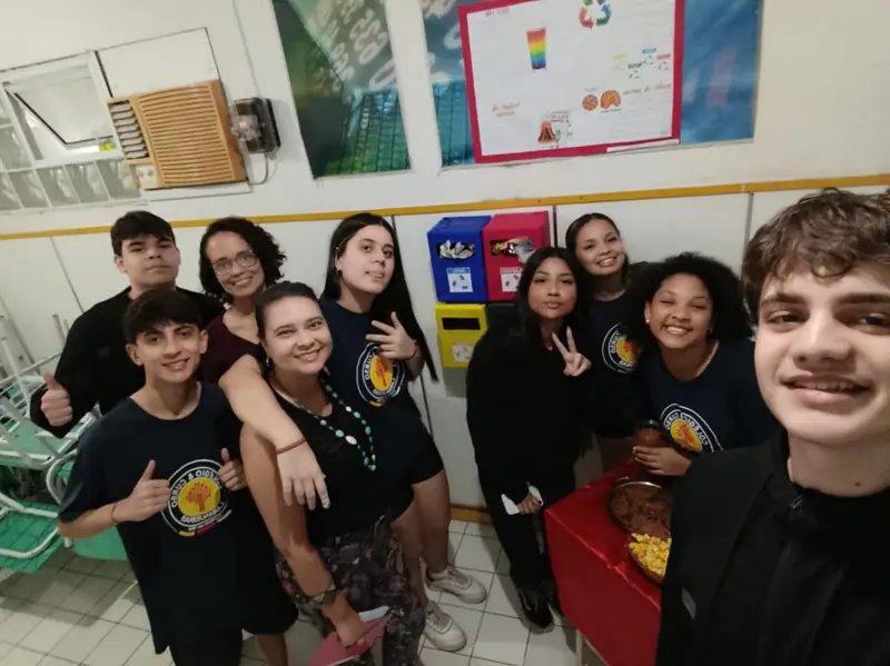 Alunos e professora reunidos em sala de aula